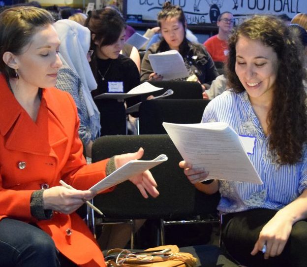 Women attendees at an in-person Work Smart workshop in Washington, D.C. participate in a salary negotiation role-playing exercise.